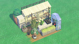 Overhead view of the ACNH Mini Flower Set showing the spooky fence behind the stall, checkout counter, greenhouse box, terrarium and wooden box