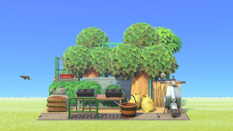 Animal Crossing Overgrown Garden Corner room design with trays of potted starter plants on a low folding table, wooden bucket, stacked bags, silver scooter, caged cart and elephant watering can behind a hedge and corrugated iron fence