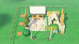 Overhead view of the ACNH Mini Outdoor Movie design showing the rope fence, stepping stones, yoga mat and magazine rack around the screen